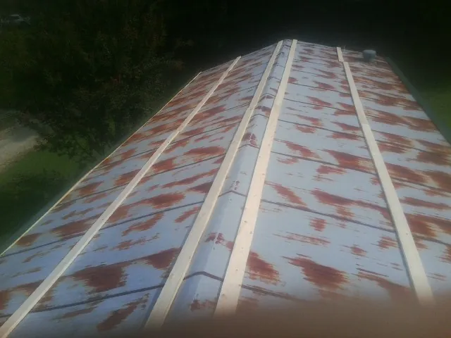 Rusted metal roof panels with new wood purlins before replacement — Storm Damage Roof Repair in Point Pleasant Beach by Roofing Brothers