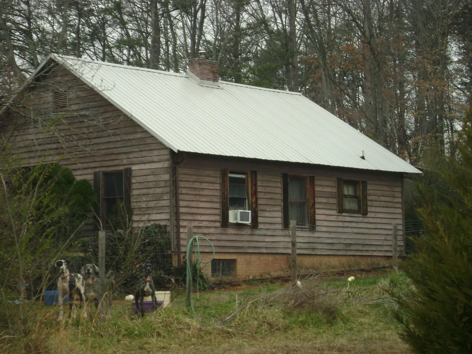 White metal roof on an old wood sided farmhouse, from a Metal Roof Installation job in Point Pleasant Beach
